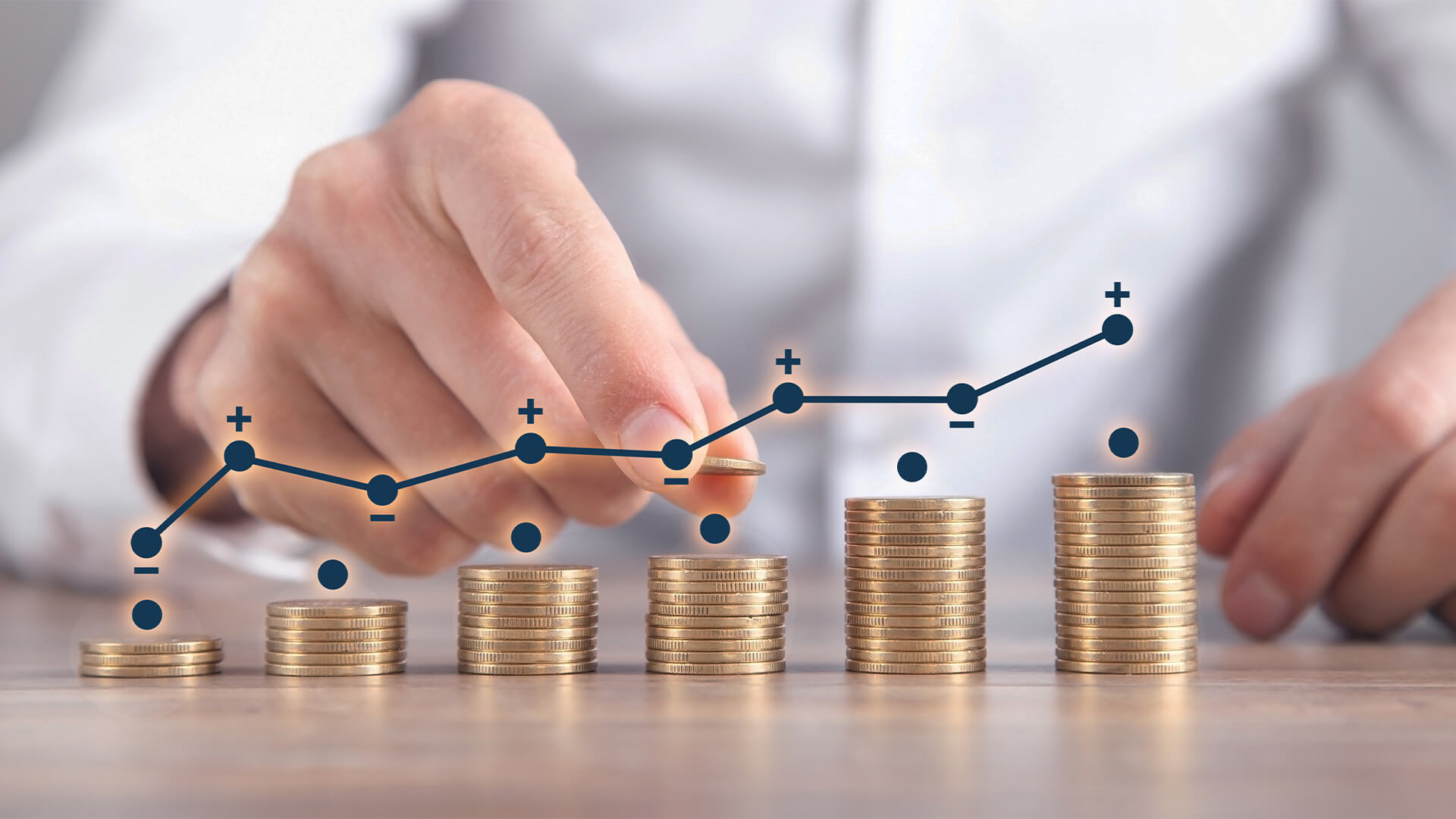 Man stacking coins with a graph of profit