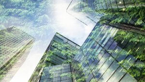 Double exposure of a skyscraper with green leafy trees