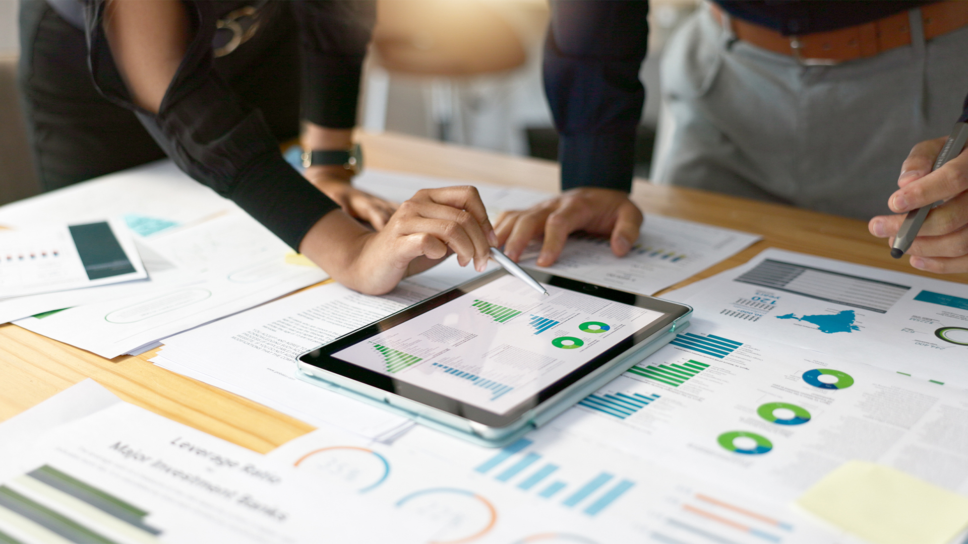 Business people, data analysis with tablet and paperwork, hands with online review in meeting and team with market research.