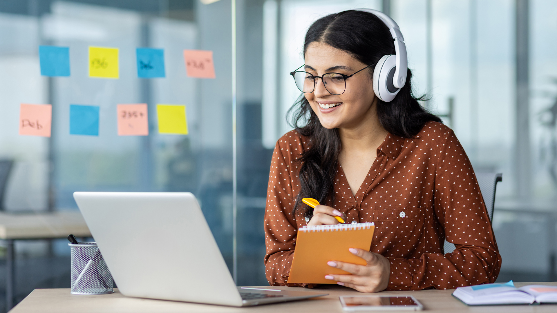 Woman watching online video course, training conference inside office at workplace.